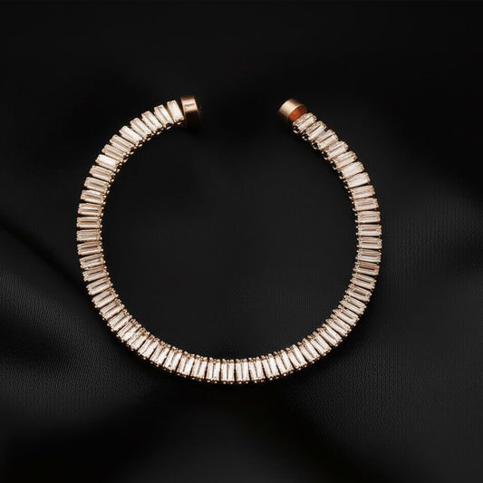 Rose gold bracelet with clear stones on a black background