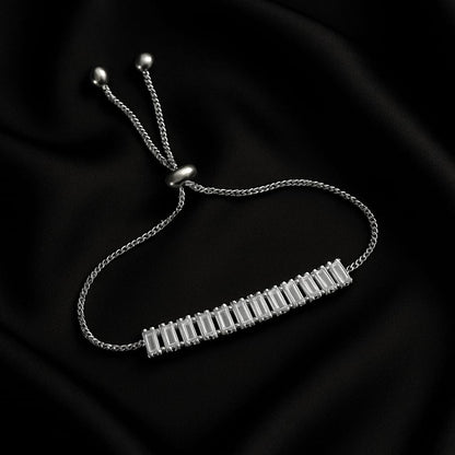 Silver bracelet with a bar design on a black background