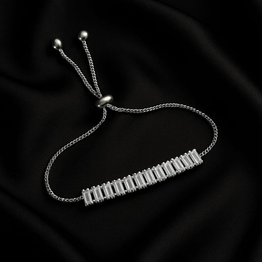 Silver bracelet with a bar design on a black background