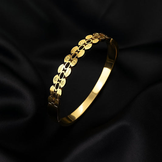 Gold bracelet on a black satin background