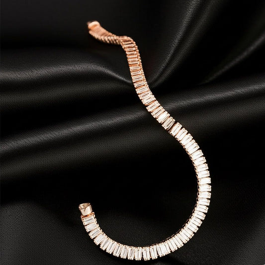 Rose gold bracelet with clear stones on a black satin background