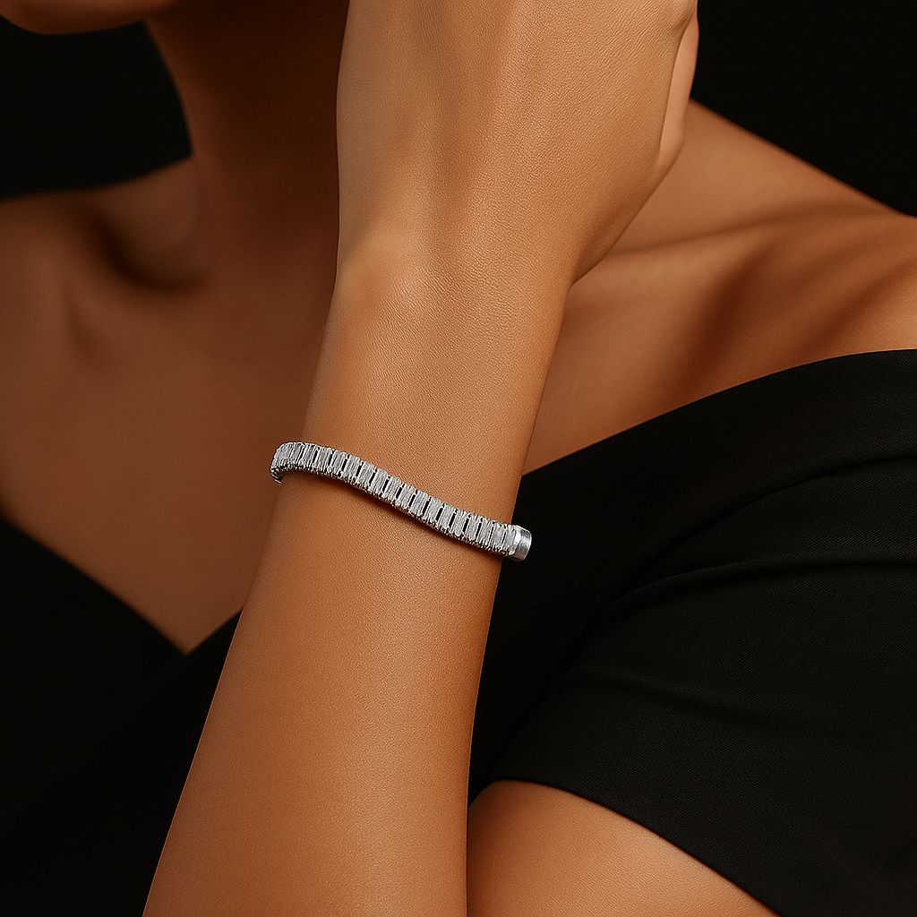 Silver bracelet on a person's wrist against a black background