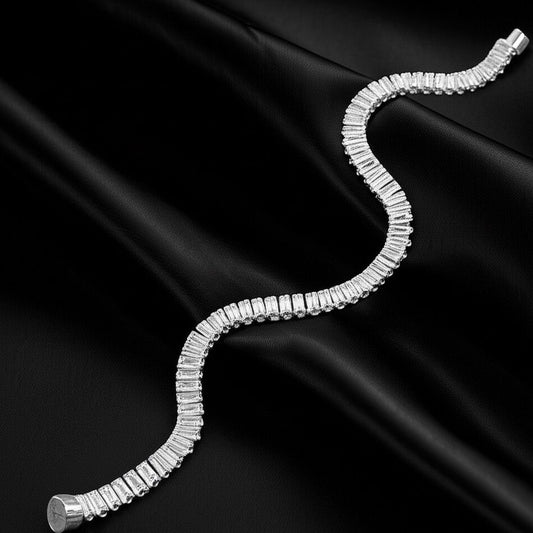 Silver rhinestone bracelet on a black satin background with magnetic closures.